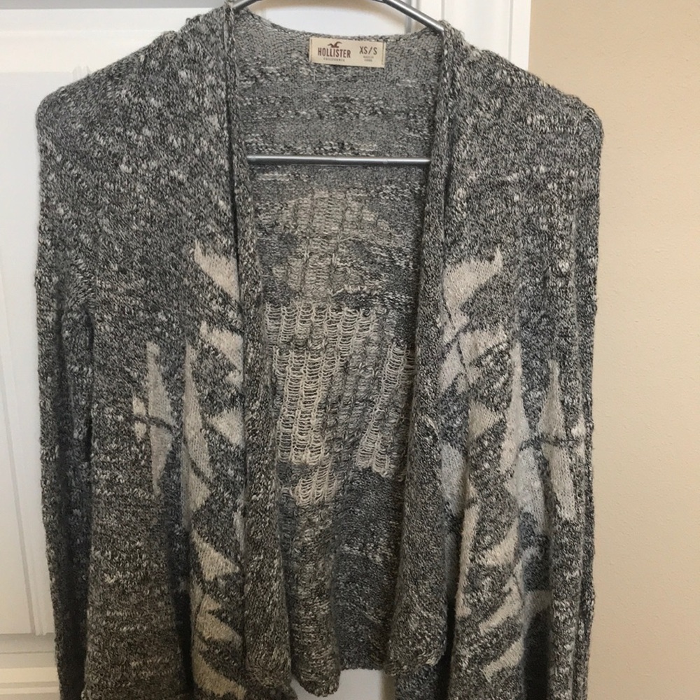 Small grey sweater with white design.